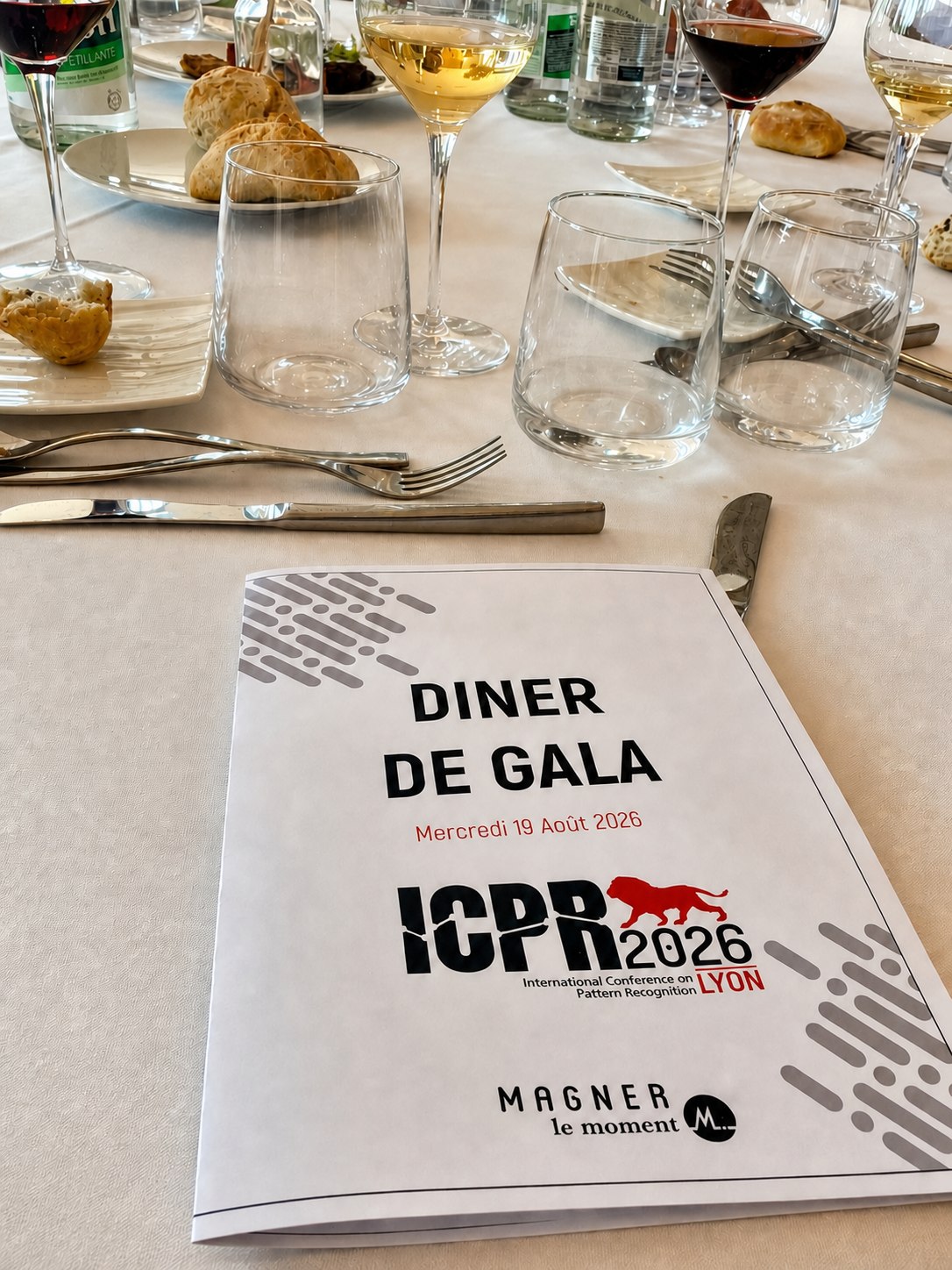 ICPR 2026 gala dinner menu surrounded by wine glasses and an elegant table setting